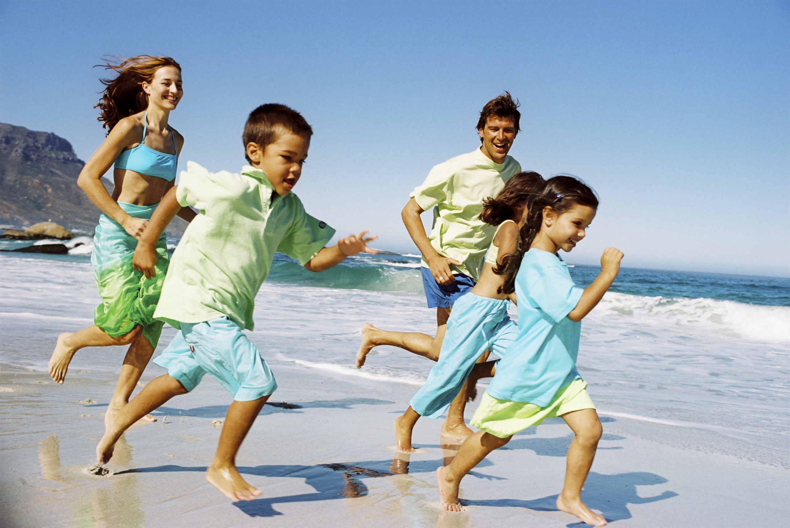 Family running on beach