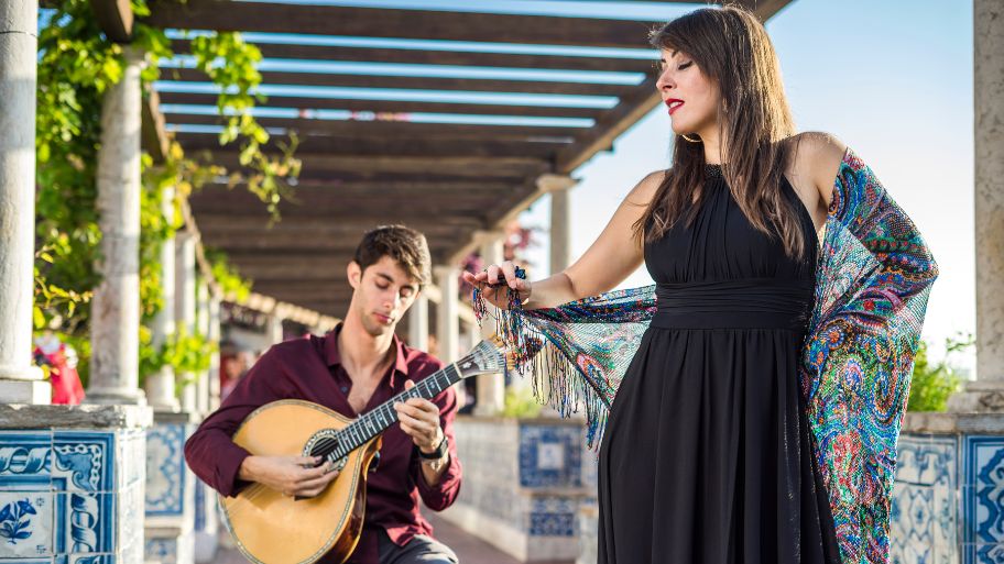 Band performing traditional music fado under pergola with azulejos in Lisbon, Portugal