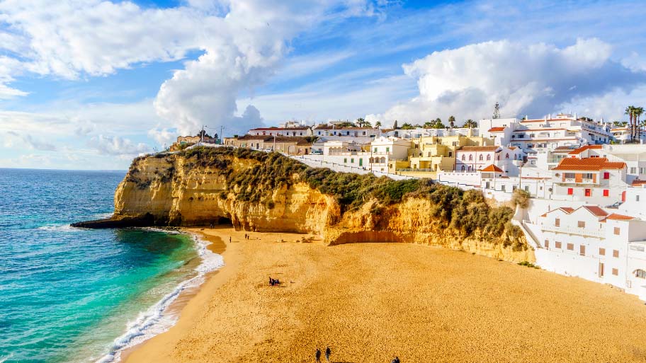 Sandy-beach-between-cliffs-and-white-architecture-in-Carvoeiro-Algarve-Portugal