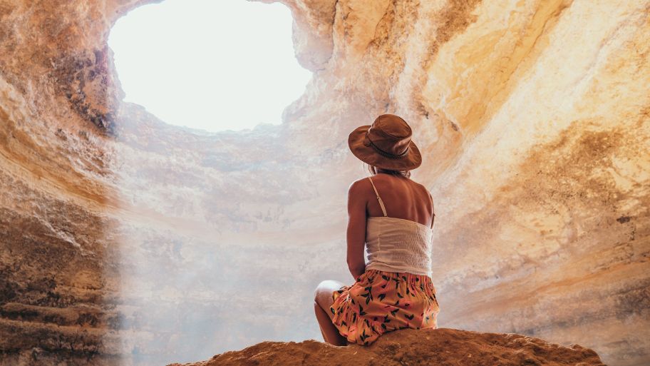 Woman contemplating caves in Portugal