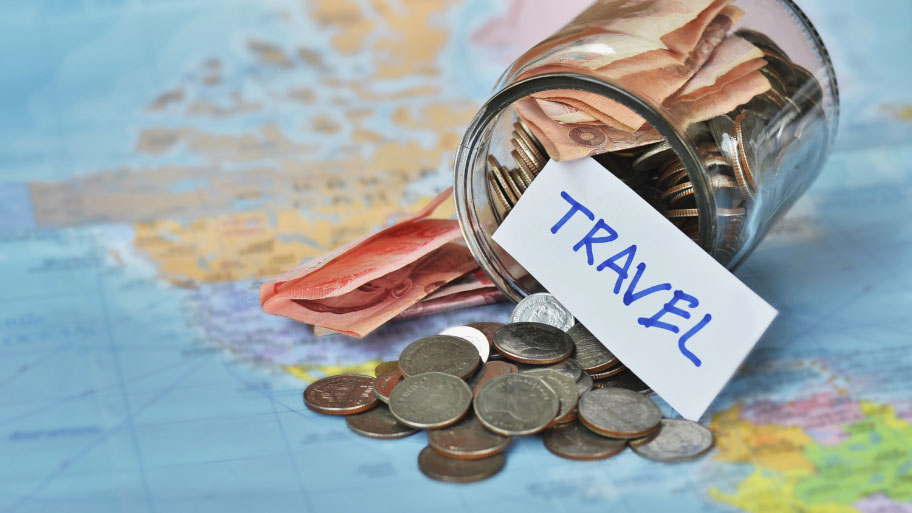 Travel budget - vacation money savings in a glass jar
