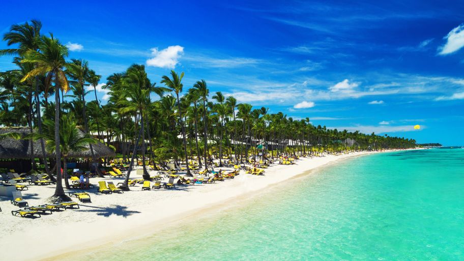 Tropical vacation in Punta Cana, Dominican Republic. Aerial view over beach resort. Parasailing. Sunbathing Tropical vacation in Punta Cana, Dominican Republic. Aerial view over beach resort. Parasailing. Sunbathing