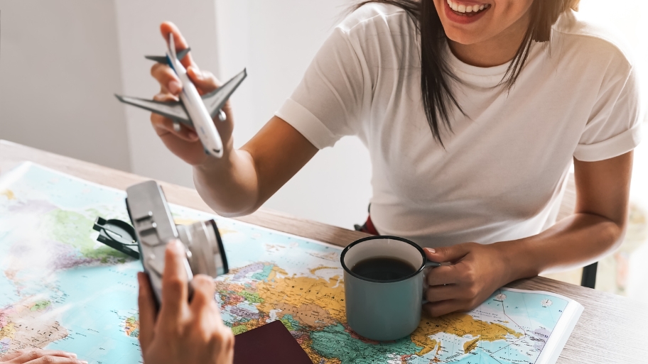 Smiling travel advisor from Allied Travel helping plan a trip—offering trusted travel agency services in Ankeny, IA for stress-free vacation planning