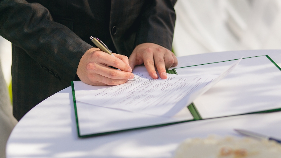 Groom signing marriage license Groom signing marriage license