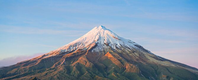 Snow-capped Mount Egmont at sunrise, a breathtaking backdrop for a New Zealand destination wedding — image provided by Allied Travel, New Zealand