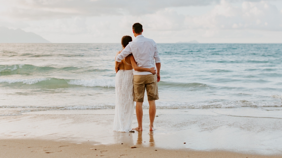 Newlywed Couple Walking on the BEach